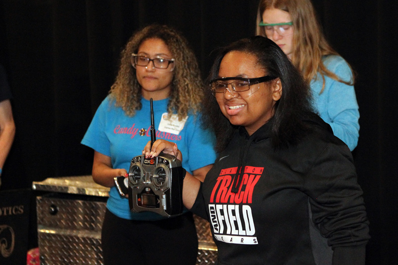 Girl smiling as she hold her controller
